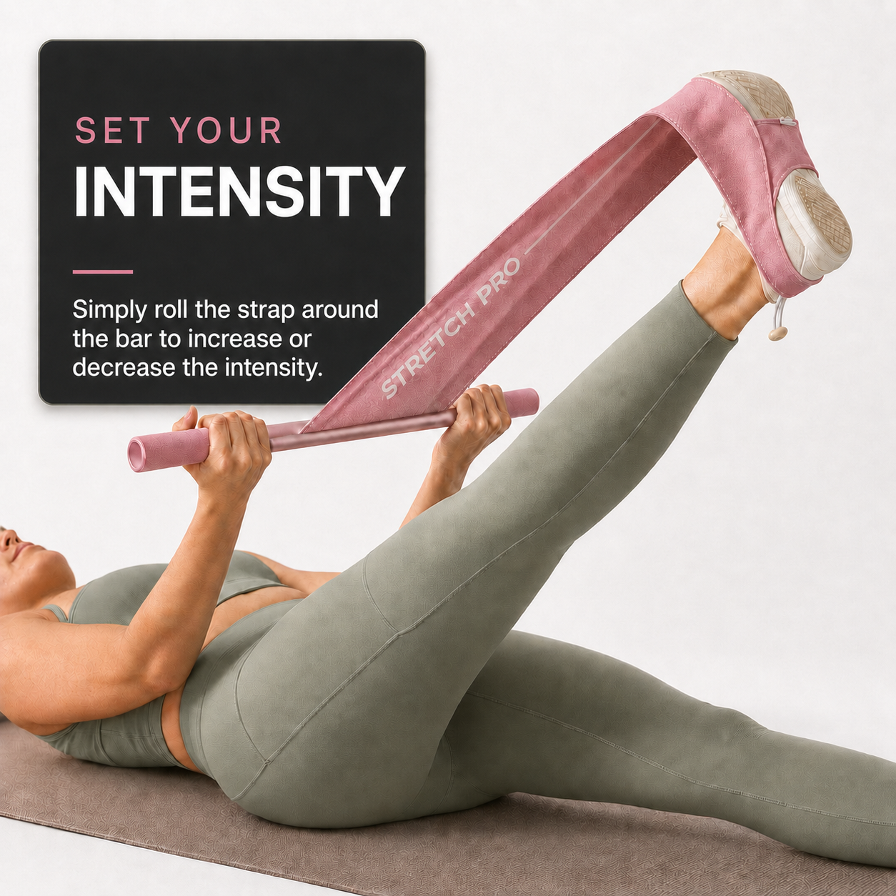 Woman using pink Stretch Pro and rolling the fabric around the bar to adjust stretching intensity