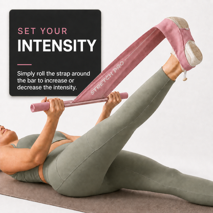 Woman using pink Stretch Pro and rolling the fabric around the bar to adjust stretching intensity